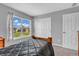 A quaint bedroom with a dark comforter, a large window, and neutral walls at 7830 Cross Creek, Avon, IN 46123