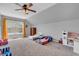 Cozy bedroom featuring carpeted floors, window, and ceiling fan at 7830 Cross Creek, Avon, IN 46123