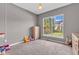 Cozy bedroom with neutral carpet, dresser, and a bright window overlooking the backyard at 7830 Cross Creek, Avon, IN 46123