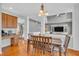 Open-concept dining area with hardwood floors, connecting to living room and kitchen spaces at 7830 Cross Creek, Avon, IN 46123