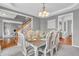 Elegant dining room with a chandelier, table set for eight, and neutral decor at 7830 Cross Creek, Avon, IN 46123