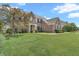 Charming brick home with manicured lawn and landscaping under a sunny blue sky at 7830 Cross Creek, Avon, IN 46123