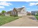 Two-car garage with a brick and vinyl exterior and manicured lawn at 7830 Cross Creek, Avon, IN 46123