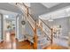 Elegant foyer with hardwood floors, staircase, and view into the dining area at 7830 Cross Creek, Avon, IN 46123