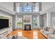 Inviting living room with large windows, a cozy fireplace, and a neutral color scheme at 7830 Cross Creek, Avon, IN 46123