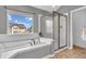 Bright bathroom featuring a soaking tub with tile surround and glass door shower at 7830 Cross Creek, Avon, IN 46123