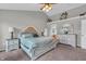 A well-lit main bedroom features high ceilings, carpet, and a beautiful bedroom set at 7830 Cross Creek, Avon, IN 46123