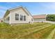 Backyard with a manicured lawn, neutral siding, multiple windows, and white picket fence at 882 Lincoln Park W Dr, Greenwood, IN 46142