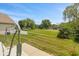 Expansive backyard featuring a lush lawn, mature trees, and charming swing bench at 882 Lincoln Park W Dr, Greenwood, IN 46142