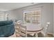Bright dining area features wood floors, a round table, and a large window at 882 Lincoln Park W Dr, Greenwood, IN 46142