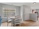Bright dining area featuring a white table, four chairs, laminate flooring and neutral paint at 882 Lincoln Park W Dr, Greenwood, IN 46142
