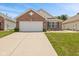 Charming single-story brick home featuring an attached two-car garage and well-maintained front lawn at 882 Lincoln Park W Dr, Greenwood, IN 46142
