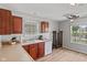 This kitchen features laminate flooring, gray walls, wooden cabinets, and stainless-steel appliances at 882 Lincoln Park W Dr, Greenwood, IN 46142