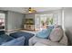 Cozy living room features plush seating, a ceiling fan, and access to the sunroom at 882 Lincoln Park W Dr, Greenwood, IN 46142