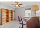 Home office featuring a desk, bookshelves, and a ceiling fan at 882 Lincoln Park W Dr, Greenwood, IN 46142
