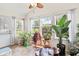 Bright sunroom with large windows and filled with plants for a serene atmosphere at 882 Lincoln Park W Dr, Greenwood, IN 46142