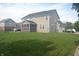 Spacious backyard featuring a well-maintained lawn and a screened-in porch at 10166 Ranford Blvd, Fishers, IN 46040