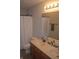Bathroom featuring dual sinks, a large mirror, and a shower with white tiling at 10166 Ranford Blvd, Fishers, IN 46040