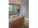 Bathroom featuring double vanity, updated fixtures, and large framed mirror at 10166 Ranford Blvd, Fishers, IN 46040