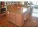 Close-up view of a kitchen island with a granite countertop and custom cabinetry at 10166 Ranford Blvd, Fishers, IN 46040