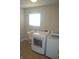 Bright laundry room with modern washer and dryer, sink, and tiled floor at 10166 Ranford Blvd, Fishers, IN 46040