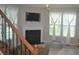 Inviting living room with fireplace, TV, and great natural light at 10166 Ranford Blvd, Fishers, IN 46040