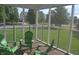 Inside the screened porch are green chairs that look out over a lush green lawn at 10166 Ranford Blvd, Fishers, IN 46040