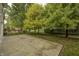 Concrete patio with a mature tree line and fenced in yard at 10246 Liverpool Way, Indianapolis, IN 46236