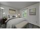 Bedroom featuring a bed, a window with light, a lamp, decorations, and a bench at the foot of the bed at 10246 Liverpool Way, Indianapolis, IN 46236