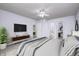 Spacious bedroom with ceiling fan, television, and furniture; accesses closet and bathroom at 10246 Liverpool Way, Indianapolis, IN 46236