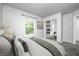 Bedroom featuring a bed, a window with light, a lamp, decorations, and a closet to another room at 10246 Liverpool Way, Indianapolis, IN 46236