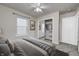 A bright bedroom includes a mirrored closet, natural light, and neutral carpet at 10246 Liverpool Way, Indianapolis, IN 46236