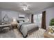 Bright bedroom featuring a ceiling fan, a large window, a comfortable bed, and stylish furniture at 10246 Liverpool Way, Indianapolis, IN 46236