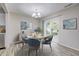 Charming dining area with a modern chandelier and a sliding door to the backyard at 10246 Liverpool Way, Indianapolis, IN 46236