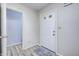 Bright entryway featuring a white front door, gray walls, and modern flooring at 10246 Liverpool Way, Indianapolis, IN 46236