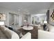 Spacious living room with modern furniture, neutral tones, and an open dining area at 10246 Liverpool Way, Indianapolis, IN 46236