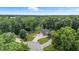Panoramic aerial view of a beautiful house surrounded by mature trees and a well-maintained lawn, offering privacy and serenity at 1066 N Dogwood Way, Greenfield, IN 46140