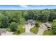 Aerial view showcasing a charming house nestled among lush trees, complete with a circular driveway and a three-car garage at 1066 N Dogwood Way, Greenfield, IN 46140