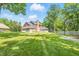 Wide shot of back of property with a spacious grassy yard at 1066 N Dogwood Way, Greenfield, IN 46140