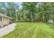 Grassy backyard with mature trees and a shed at 1066 N Dogwood Way, Greenfield, IN 46140