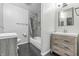Bathroom featuring double vanities, tiled shower, and wood-look flooring at 1066 N Dogwood Way, Greenfield, IN 46140