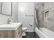 Bathroom featuring single vanity, tiled shower, and wood-look flooring at 1066 N Dogwood Way, Greenfield, IN 46140
