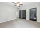 Carpeted bedroom features ceiling fan, neutral walls, and black closet doors at 1066 N Dogwood Way, Greenfield, IN 46140