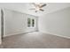 Spacious, carpeted bedroom with neutral paint, ceiling fan and large windows at 1066 N Dogwood Way, Greenfield, IN 46140