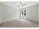 Bright bedroom with carpet floors, ceiling fan and a large window at 1066 N Dogwood Way, Greenfield, IN 46140