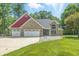 Charming brick home features a three-car garage and a well-maintained front yard with mature trees at 1066 N Dogwood Way, Greenfield, IN 46140