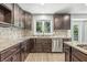 Beautiful kitchen with granite countertops, tiled backsplash, stainless steel dishwasher and lots of storage cabinets at 1066 N Dogwood Way, Greenfield, IN 46140