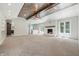 Spacious living room with a fireplace, beamed ceilings, neutral paint, and carpeted floors at 1066 N Dogwood Way, Greenfield, IN 46140