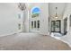 Bright living room with large windows, tall ceilings, and elegant light fixture at 1066 N Dogwood Way, Greenfield, IN 46140