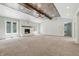Spacious living room featuring a vaulted ceiling with a striking wood beam and a cozy fireplace at 1066 N Dogwood Way, Greenfield, IN 46140
